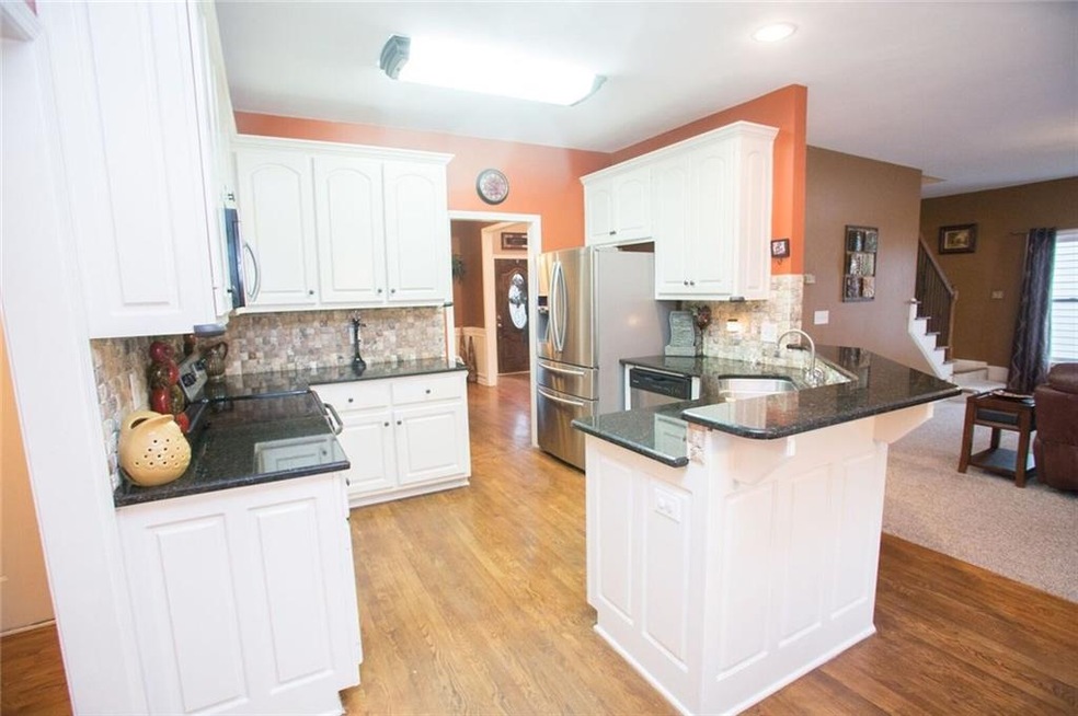 Beautiful bright and cheery kitchen with granite a