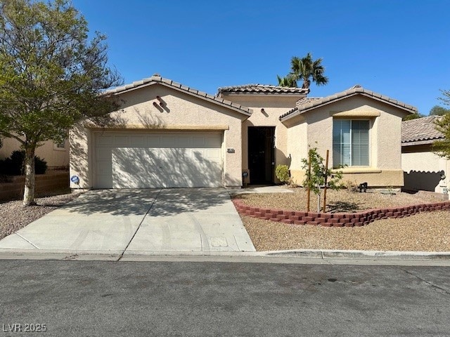 Mediterranean / spanish house featuring driveway,