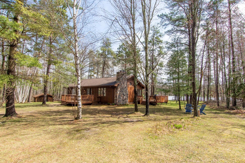 Rare find of a year round lake home with 5.7 Acres of privacy