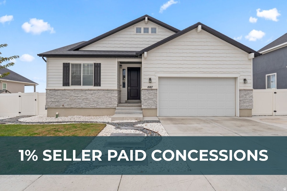 View of front facade with stone siding, a gate, driveway, and an attached garage, RV parking
