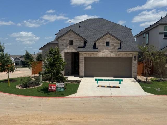 French country inspired facade featuring brick si