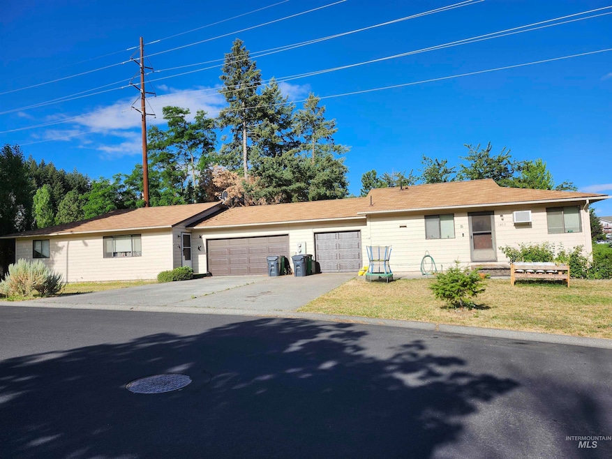 Single story home featuring a garage, driveway, and a front yard
