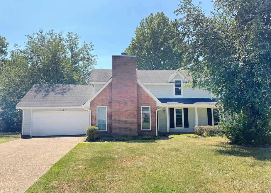 View of front facade with a garage and a front law