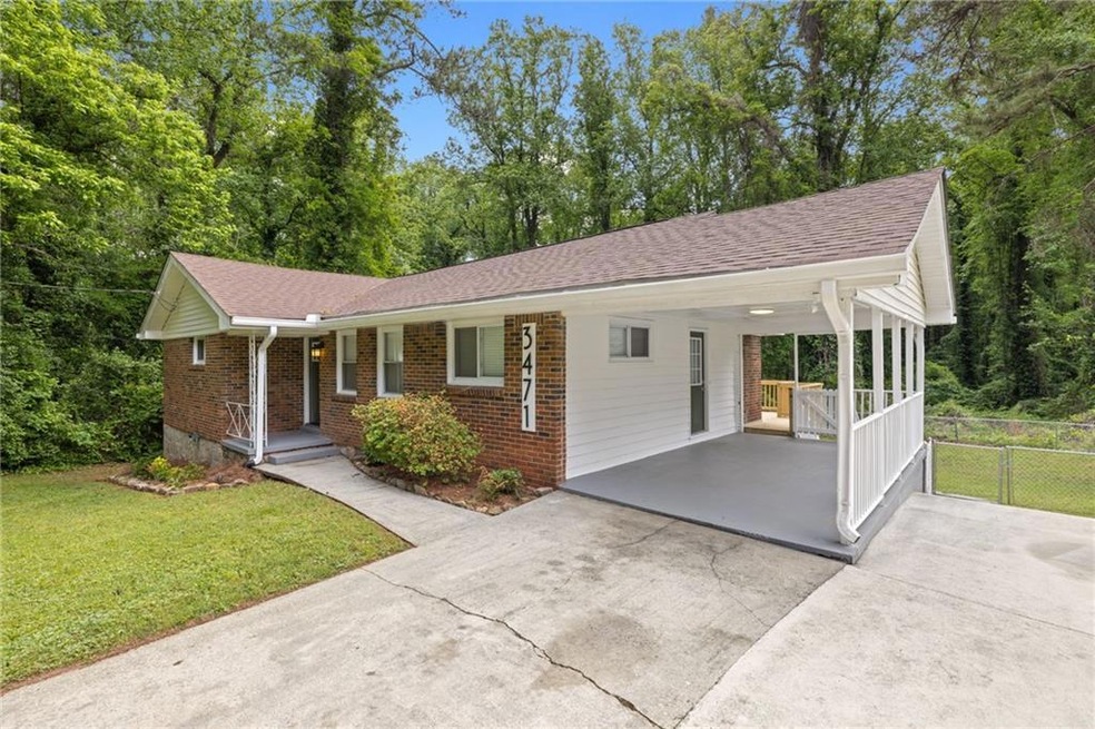 Single story home featuring brick siding, fence, a