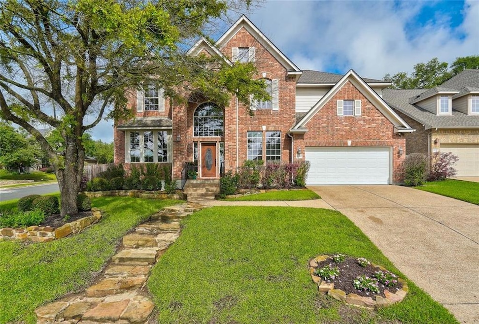 Traditional-style home with brick siding, a front