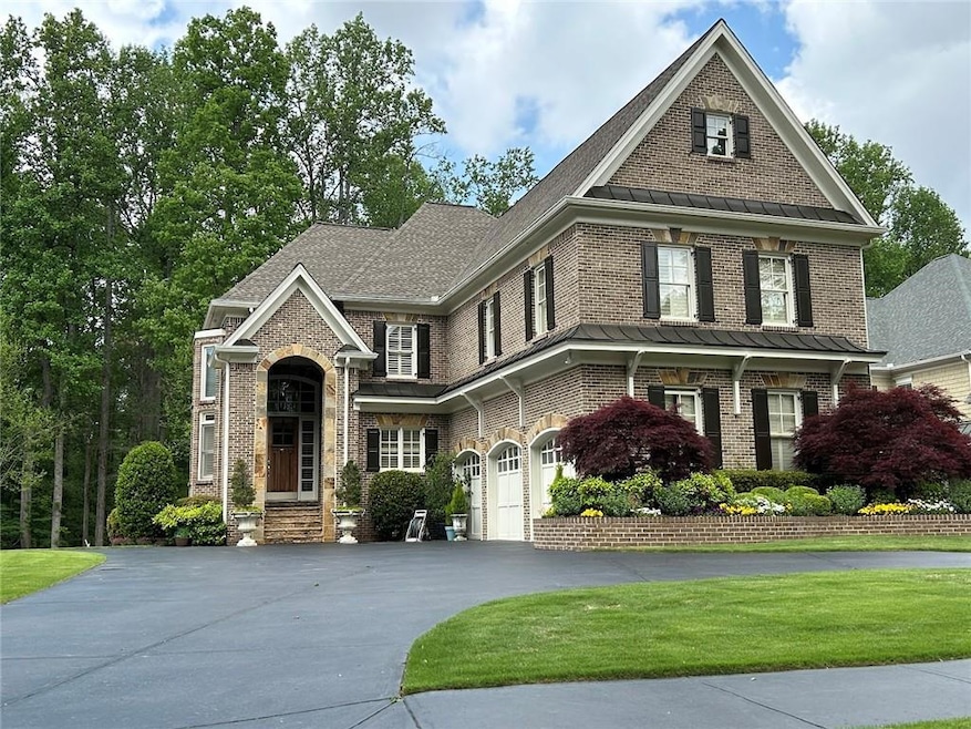 View of front of house with driveway, a standing s