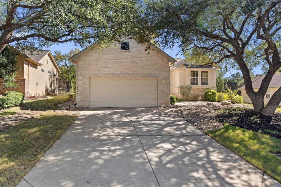 Traditional-style house featuring concrete driveway, a garage, and stone siding