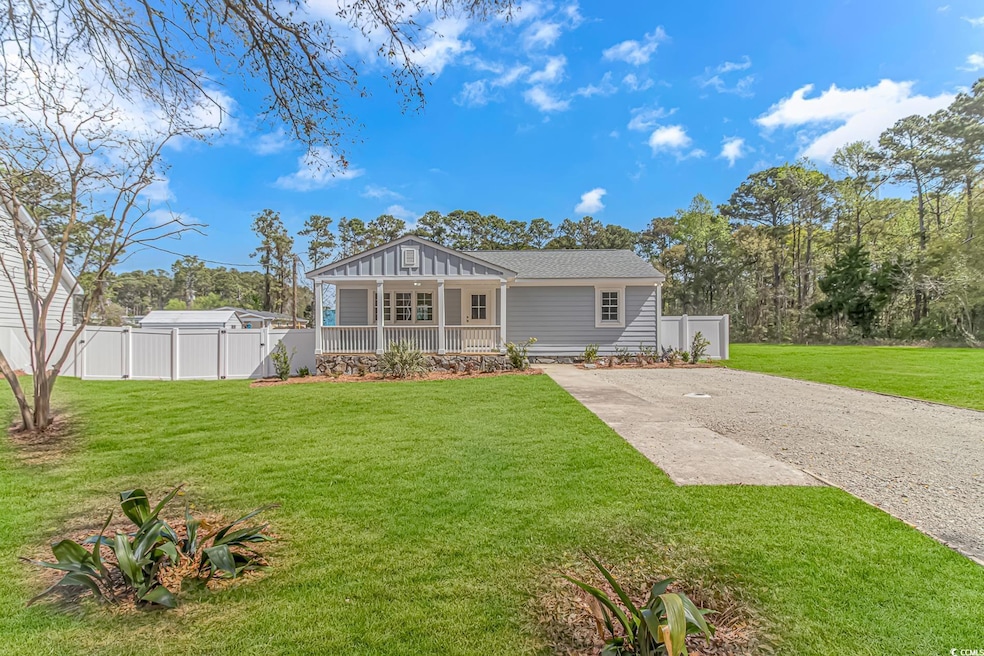 View of front facade with gravel driveway, a front