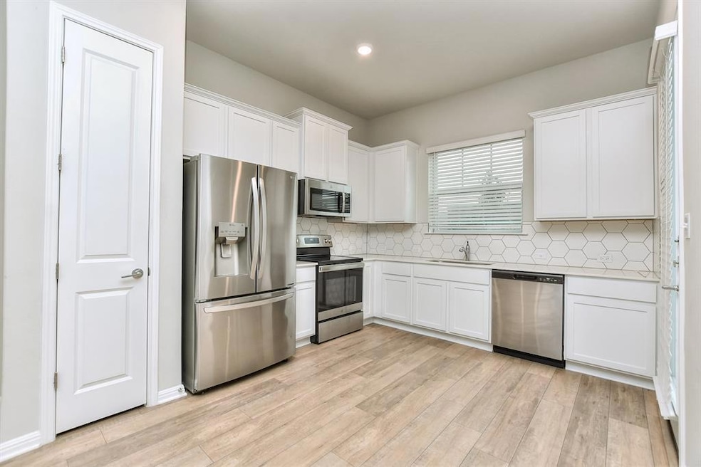 Kitchen featuring appliances with stainless steel