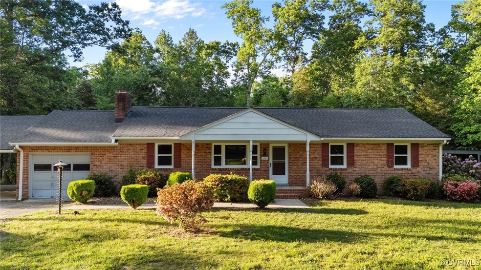 Ranch-style home with brick siding, a garage, a fr