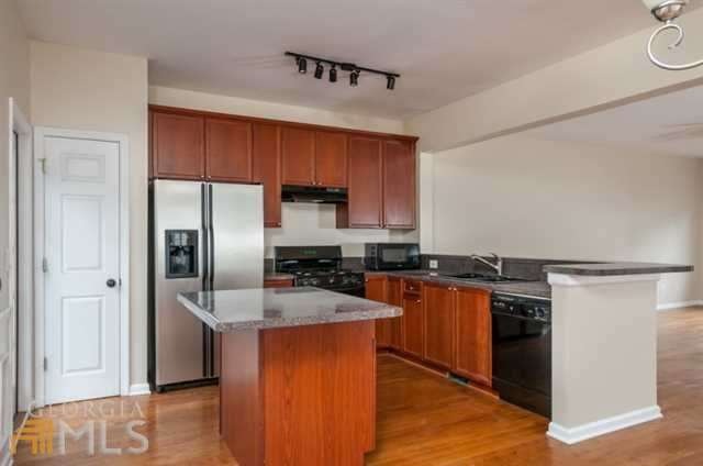 Kitchen features ample cabinet space, granite coun
