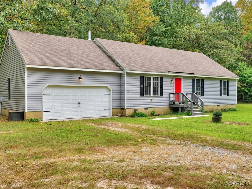 View of front facade with a front lawn and a garage