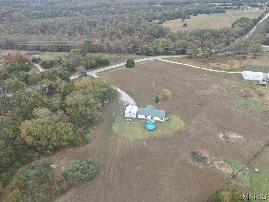 Aerial view of property and surrounding area featuring rural landscape