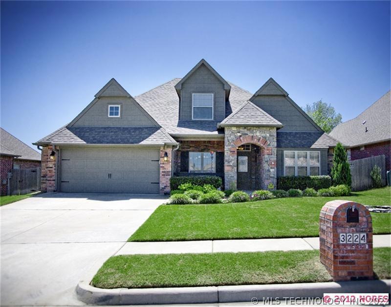 Front view showing the beautiful landscaping and c