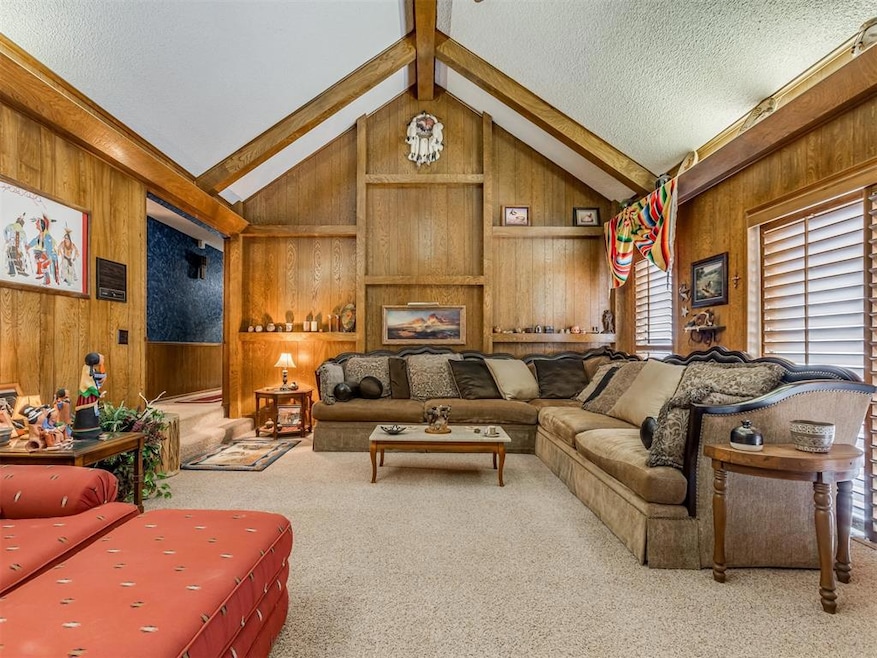 Living room with carpet flooring, wooden walls, a 