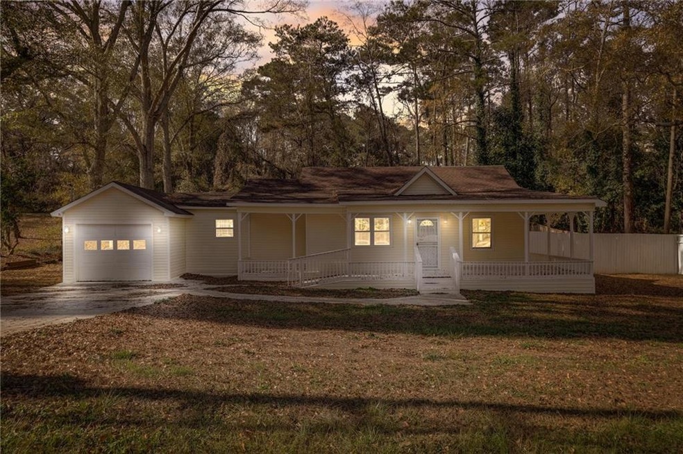 View of front of home with a garage, a lawn, and a