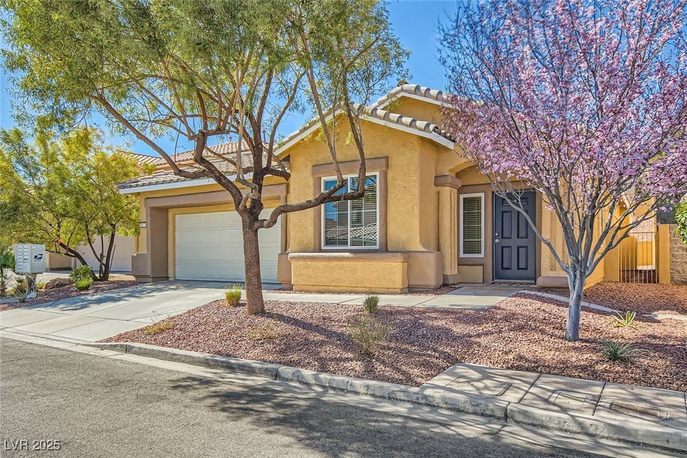 View of front of home with a tiled roof, a garage,