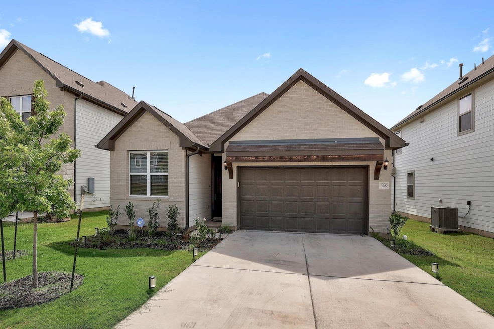 View of front of home featuring brick siding, an 