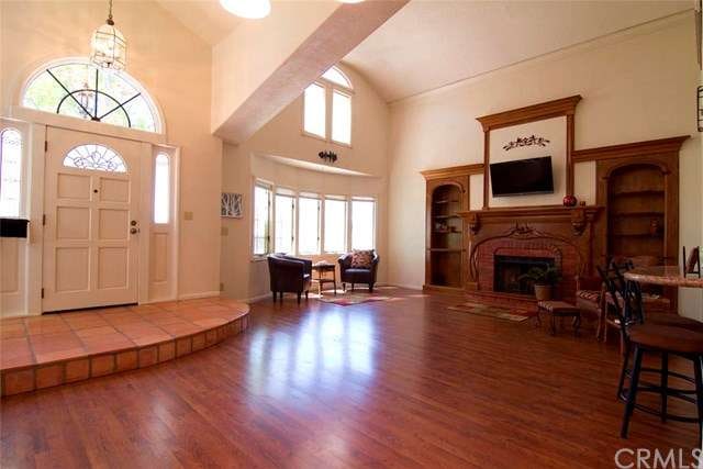 2-story living room with many windows