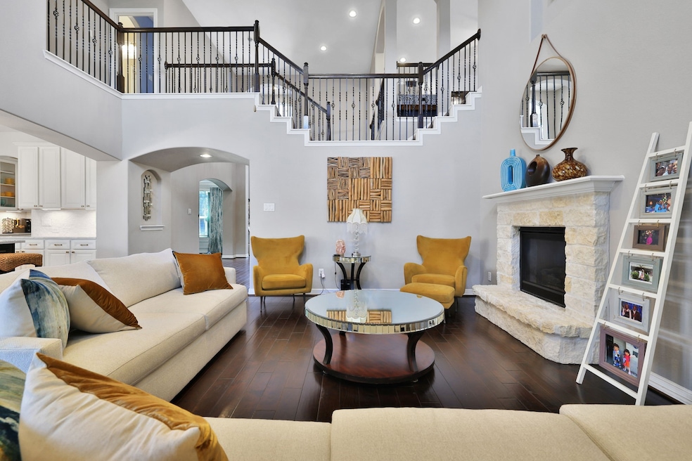 Spacious living room with soaring ceilings, a cozy