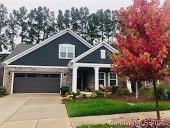 Front of home with beautiful maple tree and landsc