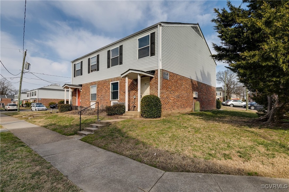 View of front of property with brick siding and a