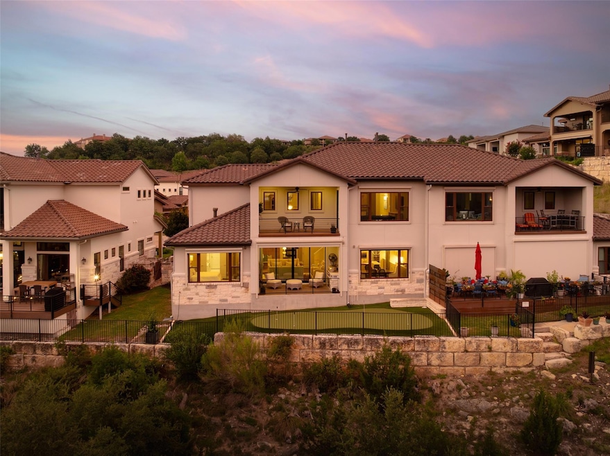 Back of house featuring a balcony, a patio area, 