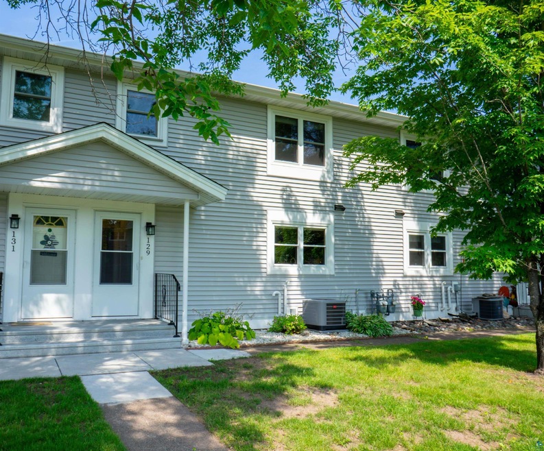 View of front of property featuring cooling unit a