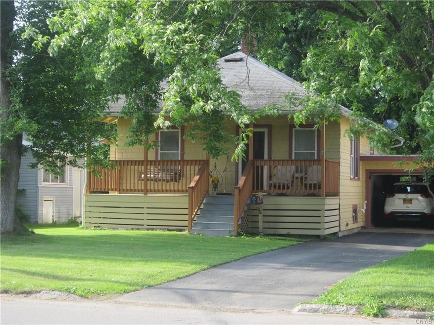 Front with newer covered porch and attached garage