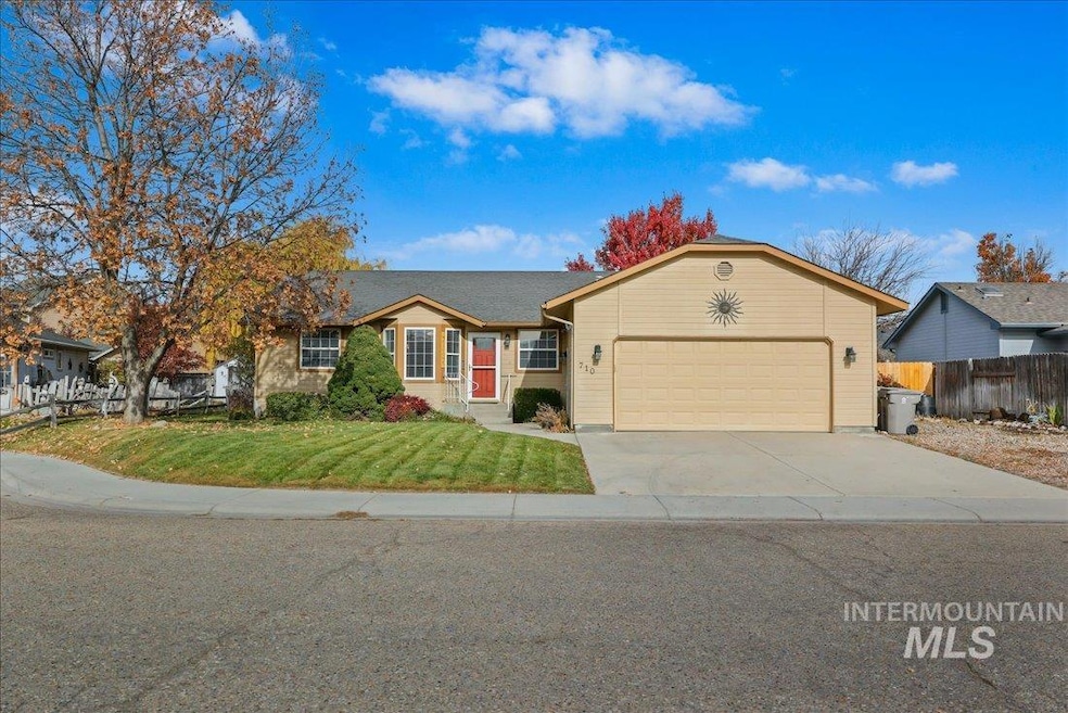 Ranch-style house with concrete driveway and an attached garage