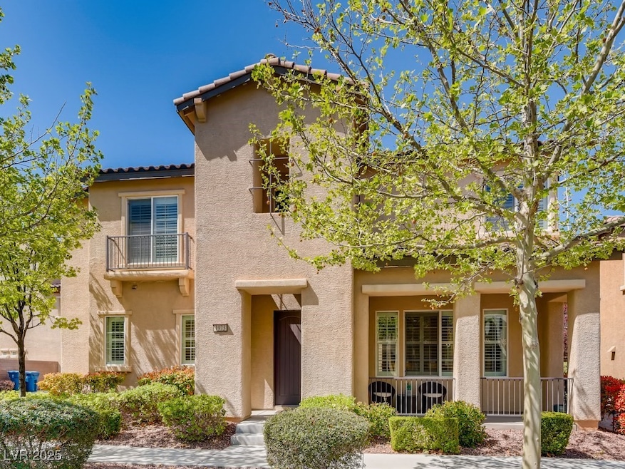View of front of house featuring a tile roof, a ba