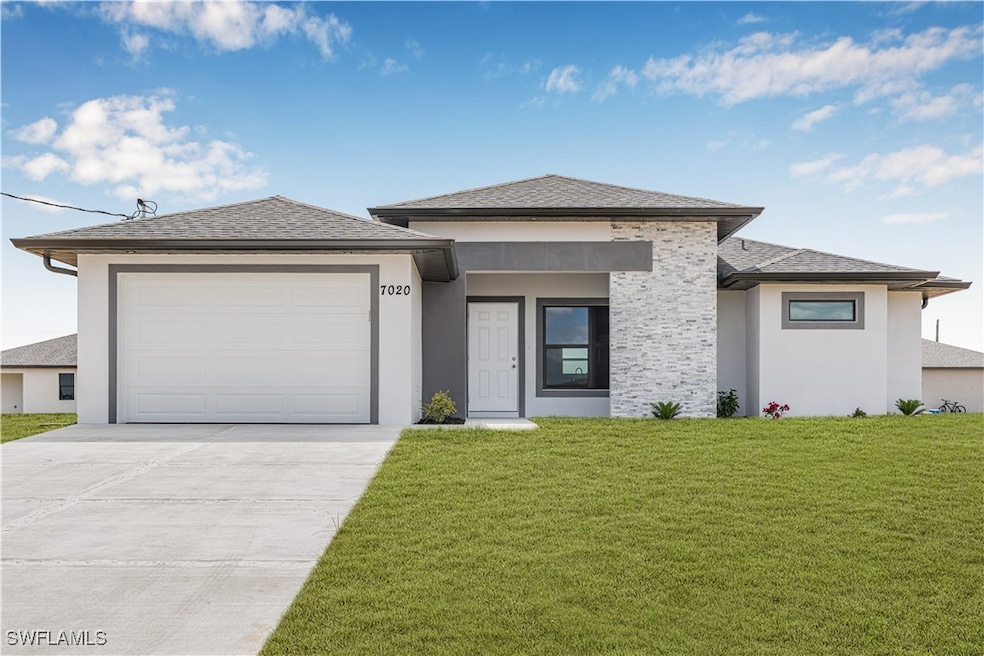 Prairie-style home with concrete driveway, a front
