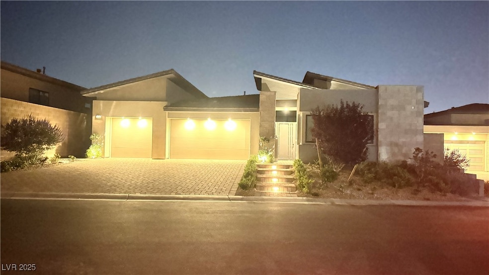 View of front of home with three car garages, over