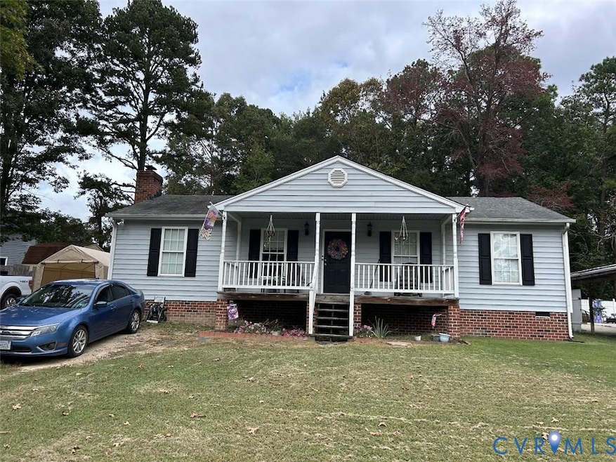 View of front of home with covered porch, a front lawn, crawl space, and a chimney