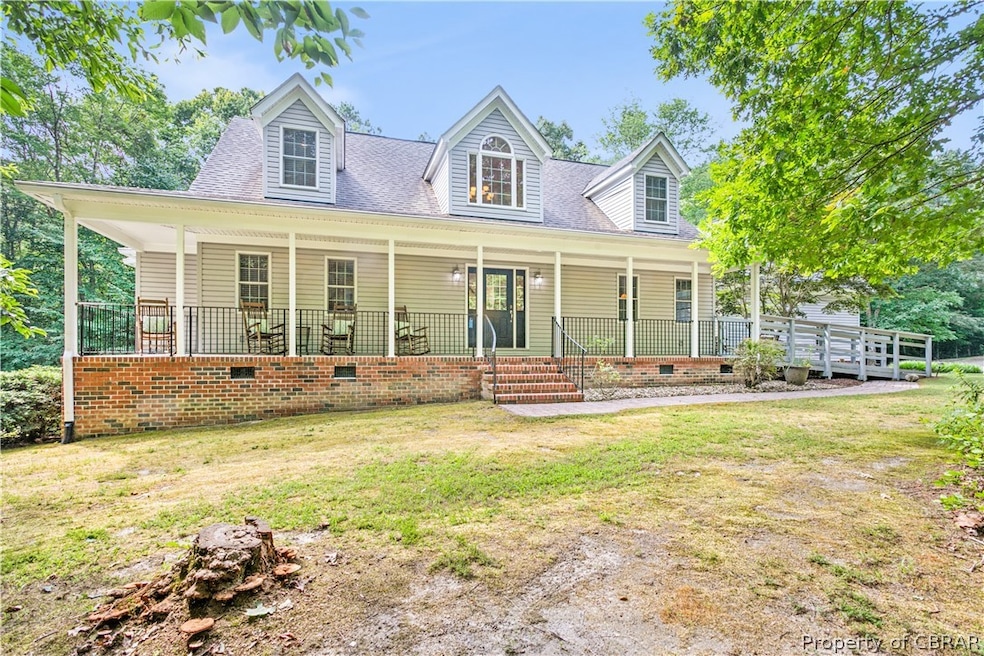 Cape cod home featuring covered porch