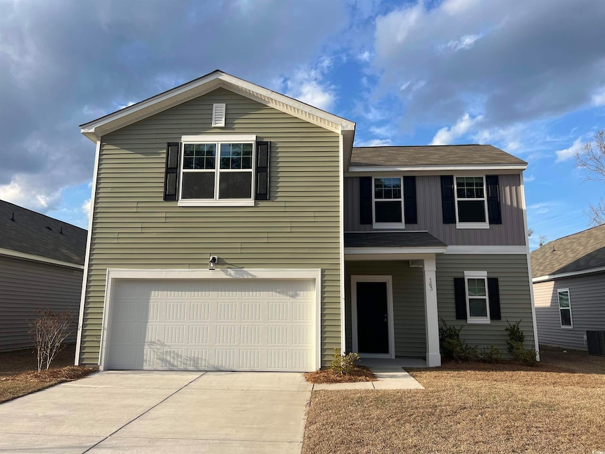 Front of property with a garage and central AC