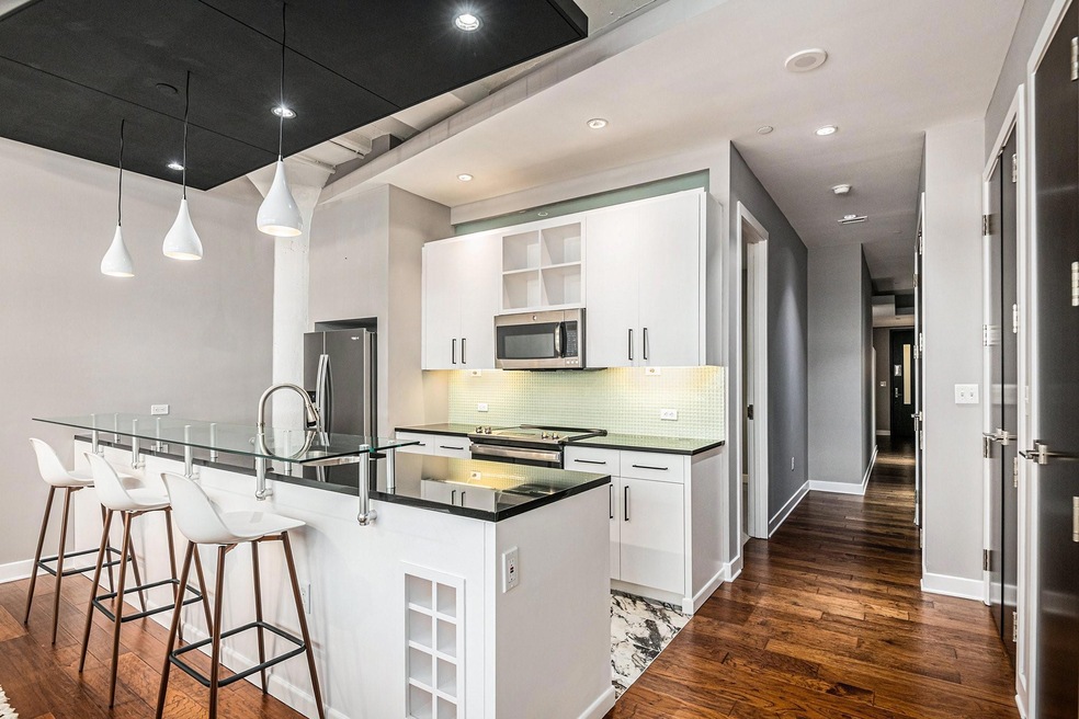 Kitchen with hanging light fixtures, appliances wi