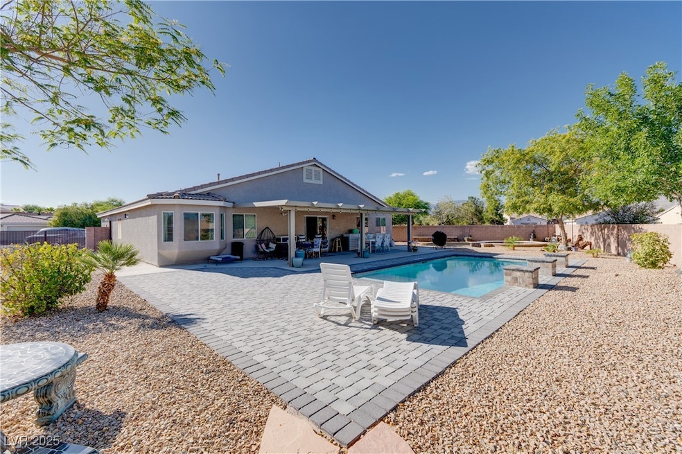 View of swimming pool featuring a patio and a back