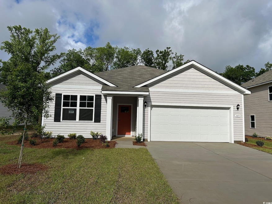 Single story home with driveway, an attached garage, and a front lawn