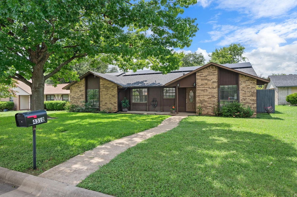Mid-century modern home featuring brick siding, a