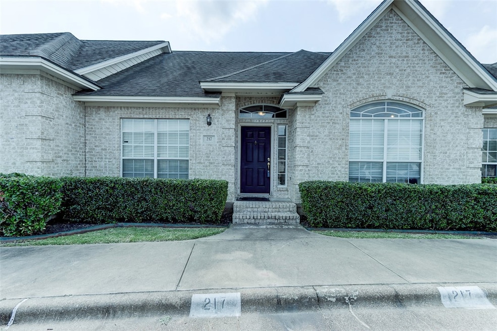 Property entrance with brick siding and roof with