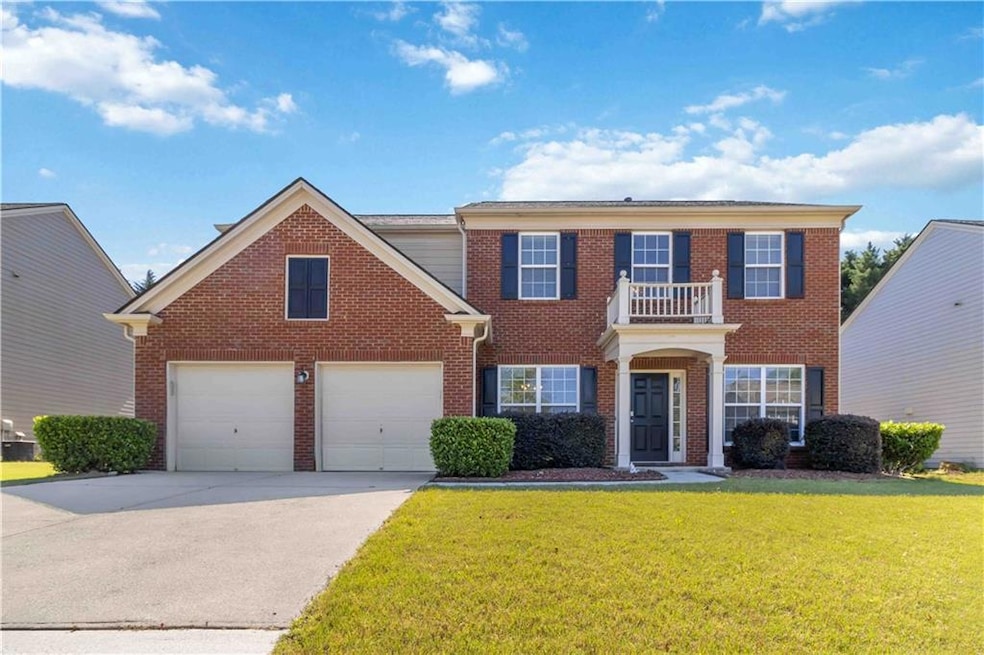 Colonial house with brick siding, concrete drivewa
