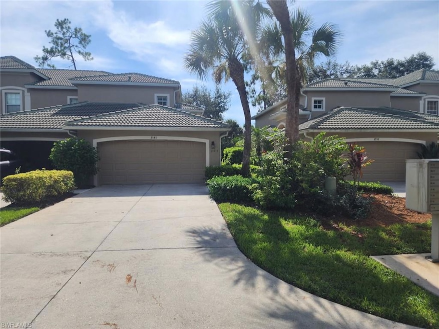 View of home's exterior featuring stucco siding, concrete driveway, a tile roof, and a garage