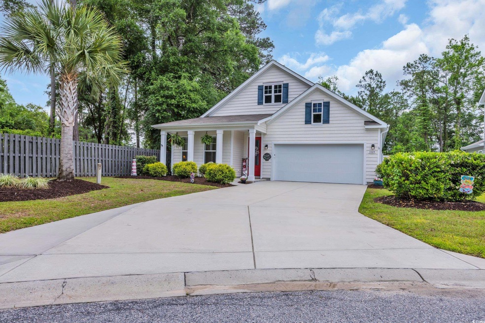 Traditional-style house with concrete driveway and