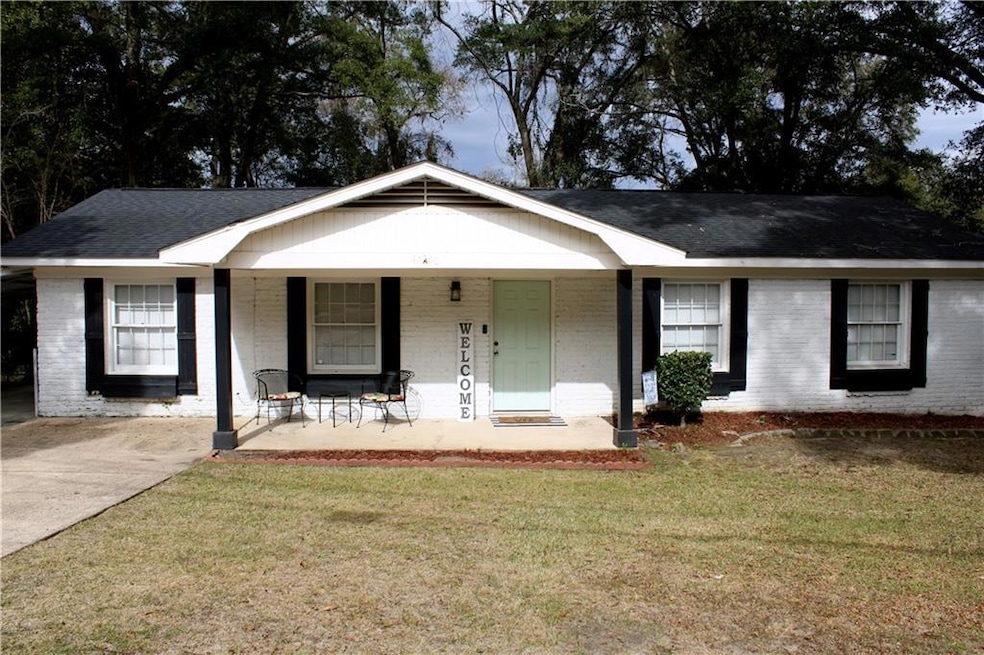 Single story home featuring a porch and a front la