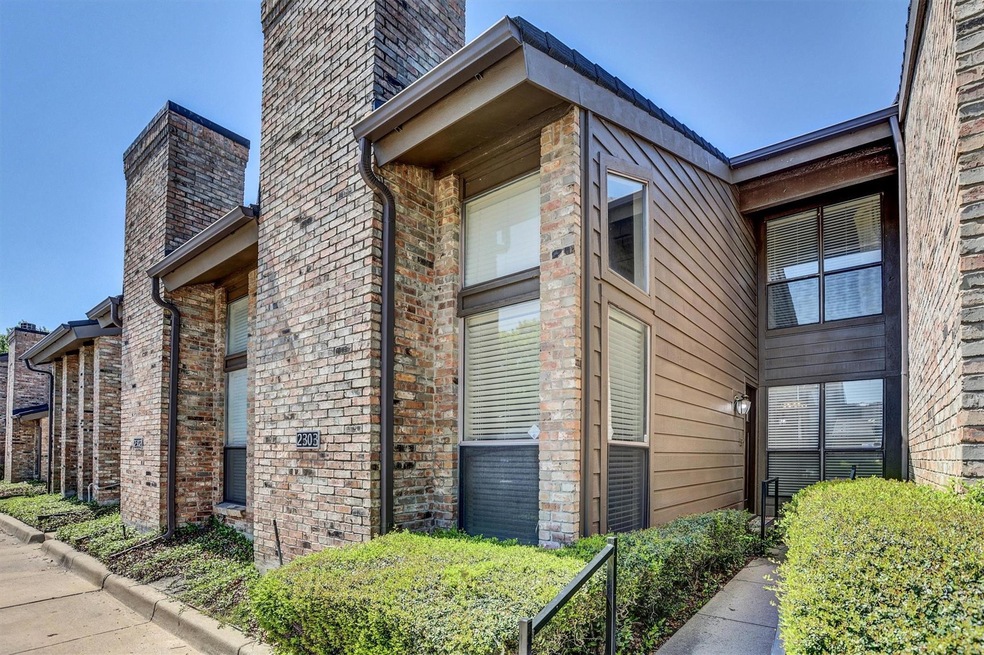 View of side of property with brick siding and a c