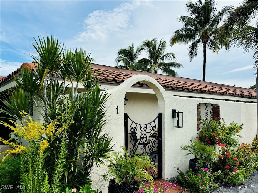 Modern kitchen featuring a peninsula, white cabinetry, appliances with stainless steel finishes, hanging light fixtures, and tasteful backsplash