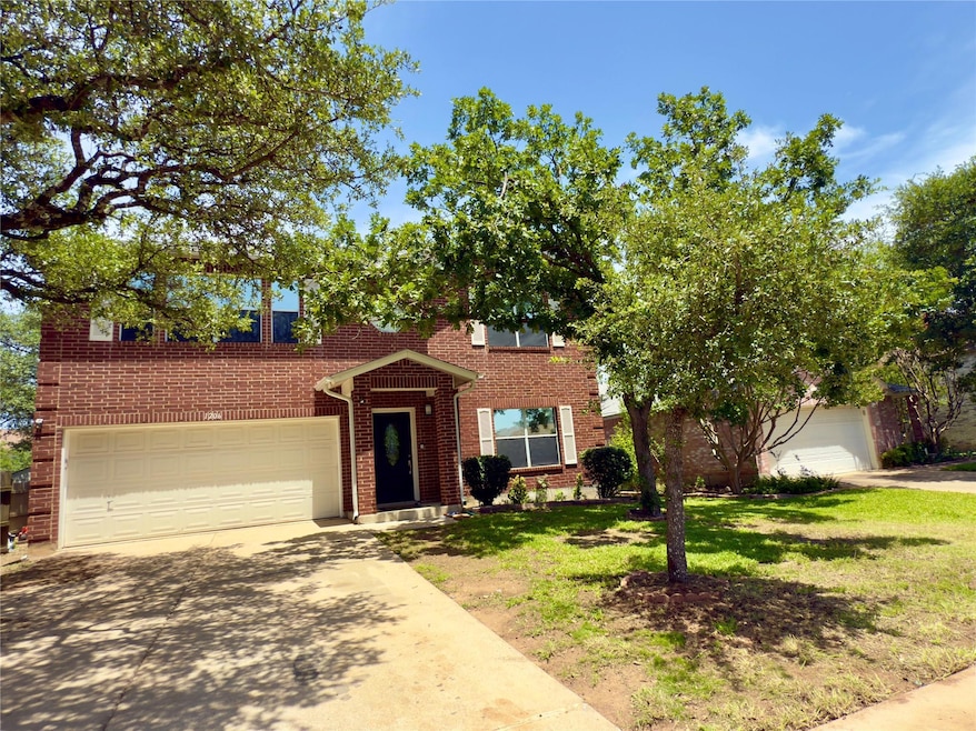 View of front facade with concrete driveway, bric