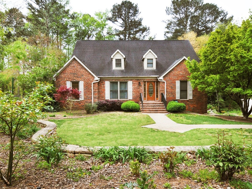 Beautifully updated 3-sides brick home in popular 