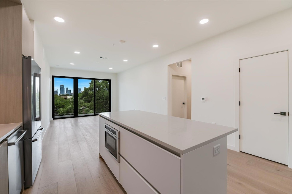 Kitchen with light wood finished floors, white ca